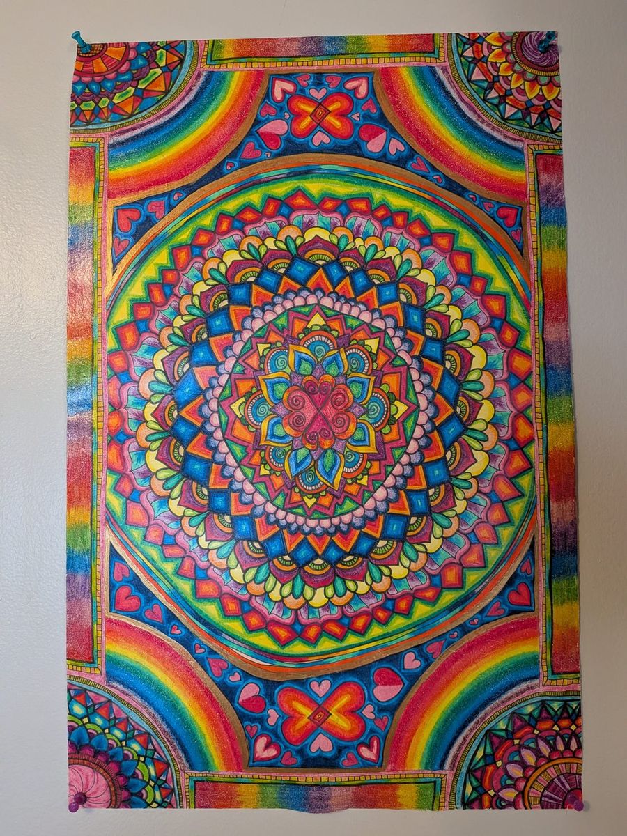A large mandala in marker and coloured pencil, with rainbow arcs in each corner